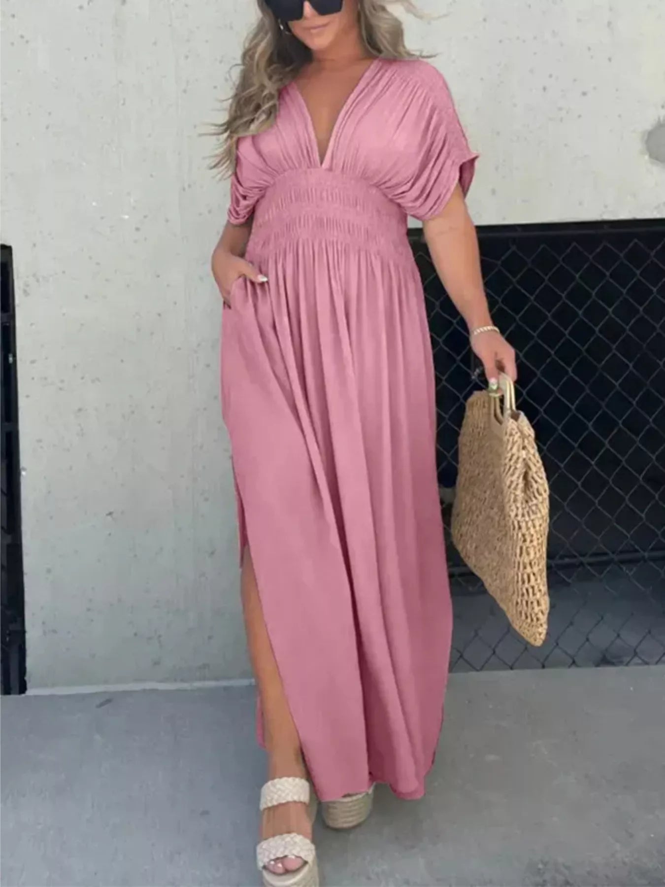 Plus size full-length maxi dress with slit, V-neck, and smocked waist by Trendsi, shown in a stylish, flowing design.