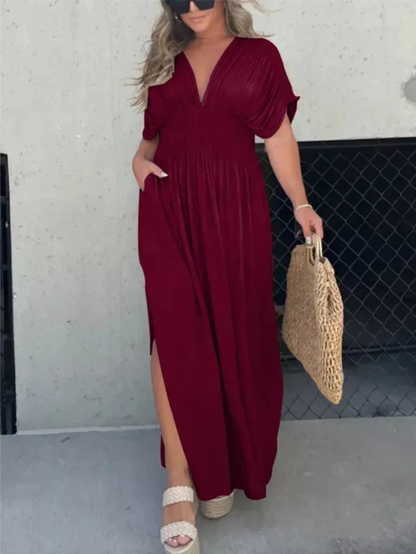 Full size slit V-neck smocked waist maxi dress by Trendsi, with flowing fabric and elegant design, shown on a model.