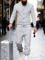 Men's plus size striped snap down top and matching pants set by Trendsi, featuring a stylish full-length design and bold pattern.