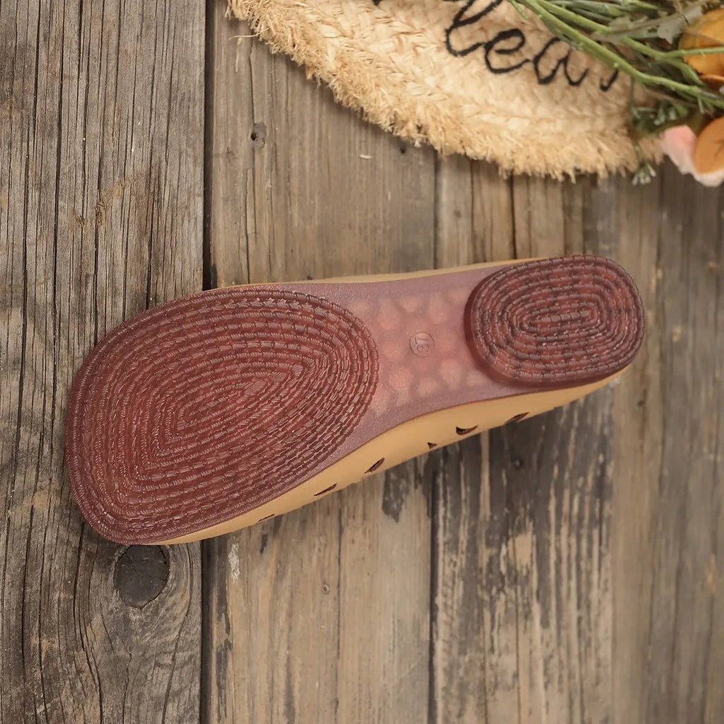 Women's hollow-out breathable slip-on shoes by Trendsi, featuring a lightweight, casual flat design with open cut-out details for comfort.