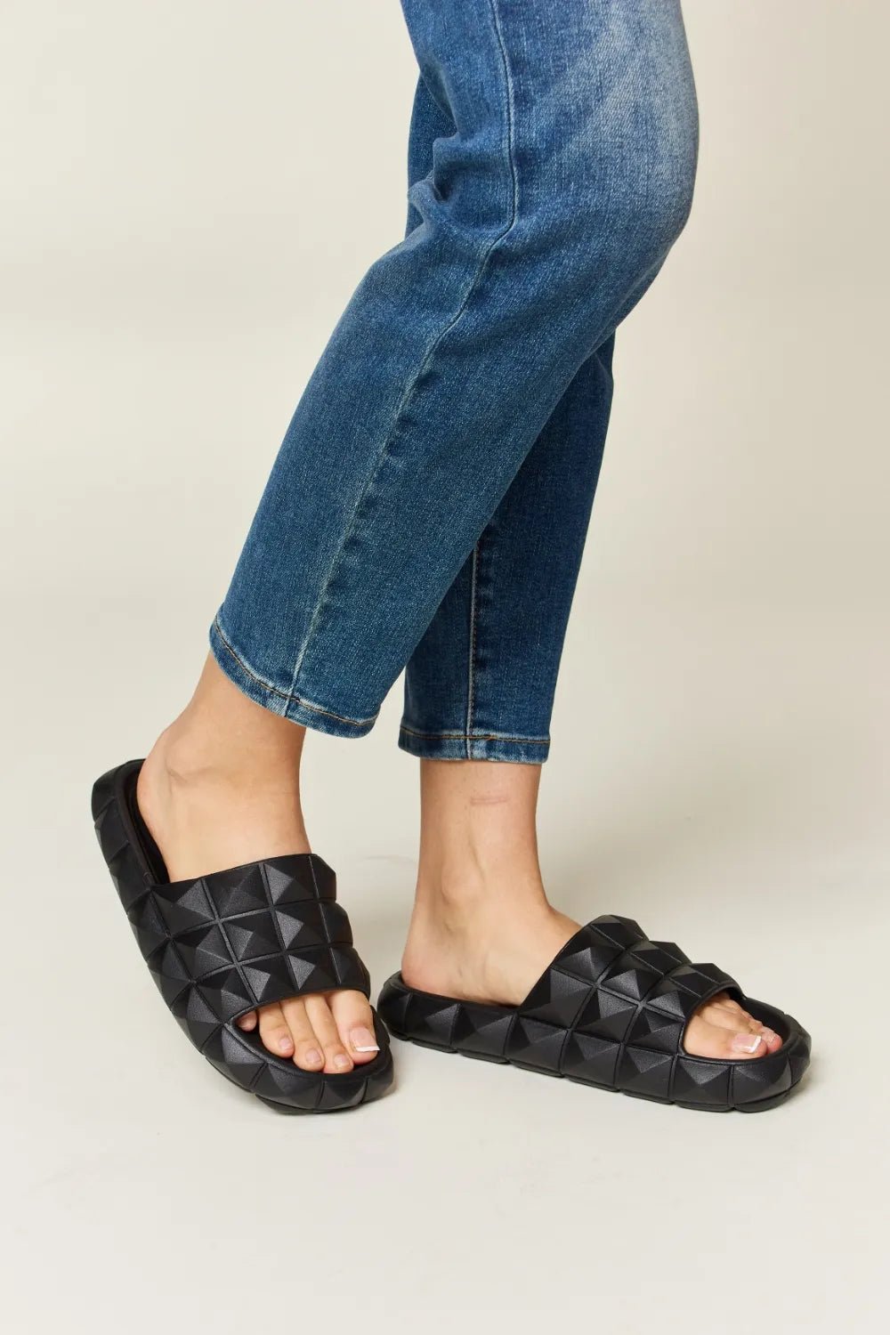 Women's Edgy Comfort Slides with pyramid studded toe band and footbed design from Trendsi, featuring a stylish open-toe sandal.