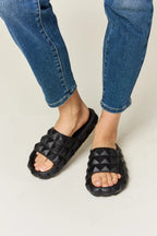 Women's studded toe band footbed sandals with pyramid studs and edgy design, featuring comfortable slide shoe style by Trendsi.